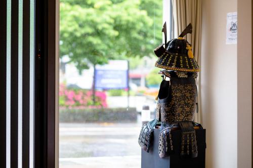 a mannequin wearing a hat hanging in a window at Fujiyoshida - House - Vacation STAY 82956 in Fujiyoshida