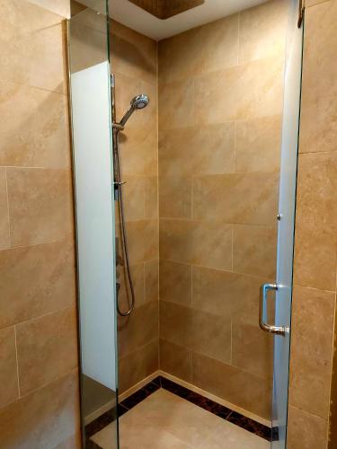 a shower with a glass door in a bathroom at Espana Resort Pattaya Jomtien in Jomtien Beach