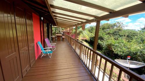 a porch with two chairs and a table on it at Condomínio Eco Resort Lençóis in Barreirinhas