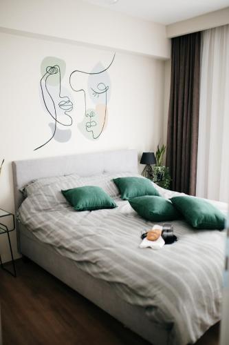 a bedroom with a large bed with green pillows at VIP apartments Bitola in Bitola