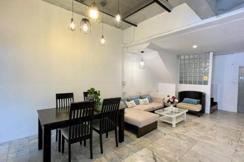 a living room with a table and a couch at Cafe home in Chiang Mai