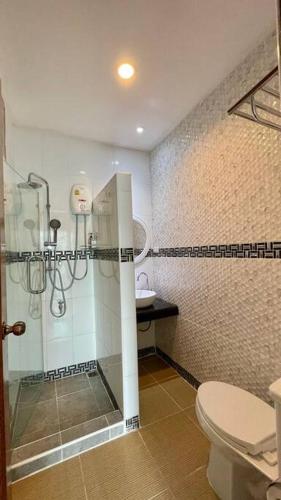 a bathroom with a shower and a toilet at Cafe home in Chiang Mai