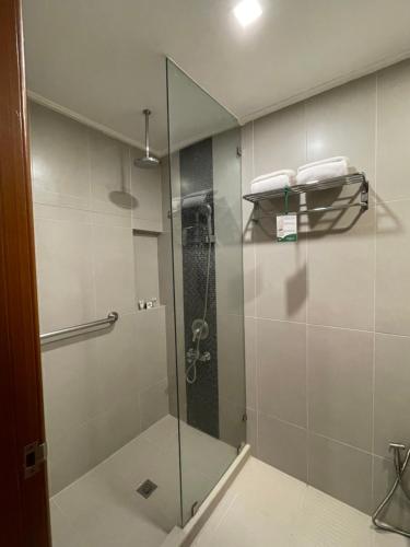 a bathroom with a shower with a glass door at Days Hotel by Wyndham Iloilo in Iloilo City