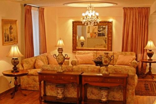 a living room with a couch and a mirror at Korina Gallery Hotel in Vathi, Ithaka
