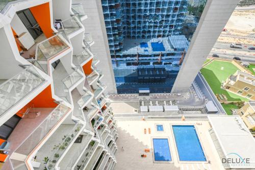 an aerial view of a building with a pool at Urban 1BR at Binghatti Stars Dubai Silicon Oasis by Deluxe Holiday Homes in Dubai