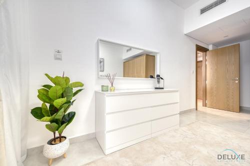 a bathroom with a mirror and a plant at Urban 1BR at Binghatti Stars Dubai Silicon Oasis by Deluxe Holiday Homes in Dubai