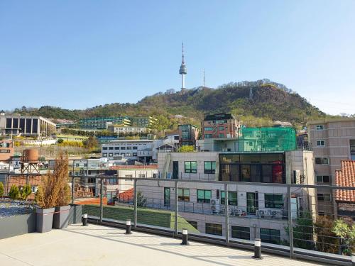 a view of a city with a hill in the background at YOLO Guesthouse in Seoul