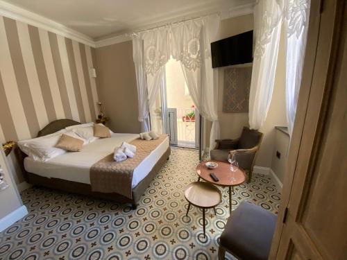 a hotel room with a bed and a table at The world suite in Tropea