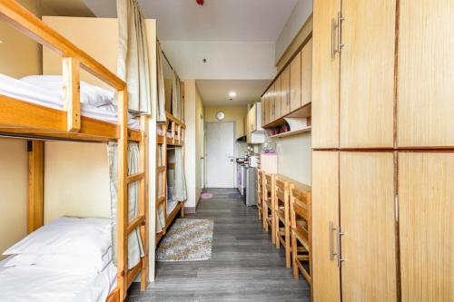 a corridor of a dorm room with bunk beds at Stunning urban view at Vista Heights Legarda in Manila