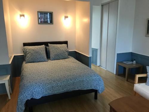 a bedroom with a bed with two pillows on it at Historical Center- Le Studio de St-Sauveur in Dinan