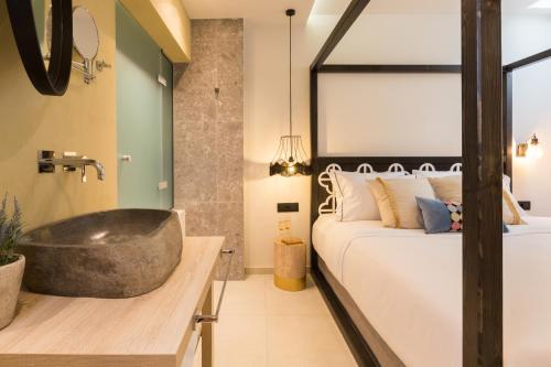 a bedroom with a large bath tub next to a bed at C Suites in Rethymno Town