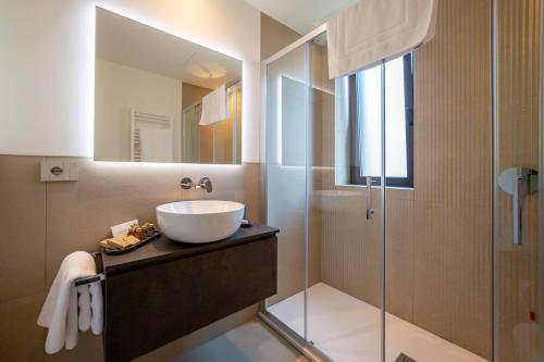 a bathroom with a sink and a shower at Le Stanze del Lago Villa Seta in Como