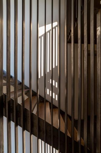 a cage with a shadow of a building behind it at Le Stanze del Lago Villa Seta in Como