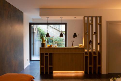 a kitchen with a counter and a large window at Le Stanze del Lago Villa Seta in Como
