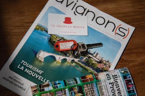 a magazine with a toy car on top of it at Le Chapeau Rouge au coeur du centre historique in Avignon