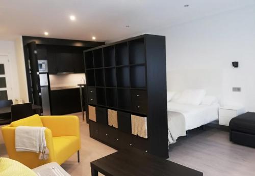 a bedroom with a large black cabinet and a bed at Casa Baratura in Cangas del Narcea