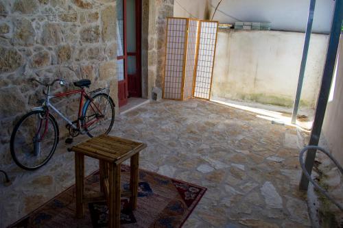 a bike parked in a room with a stool at Michael Apartment in Áyios Andréas Messinias