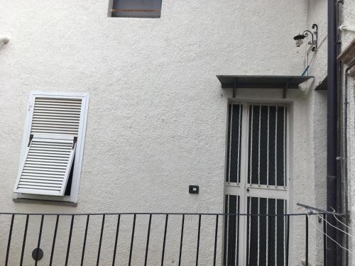 a white building with a window and a fence at I 3 FRATELLI in Foligno