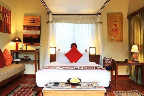 a bedroom with a large bed and a couch at Villa with private pool at Villa Nirvana Ubud in Ubud