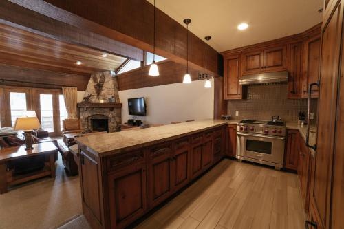 a kitchen with wooden cabinets and a stove top oven at Flagstaff Three Bedroom Suite with Majestic Mountain Views condo in Park City