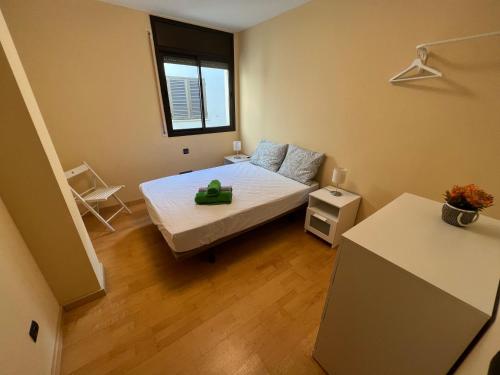 een kleine slaapkamer met een bed en een raam bij La Chartreuse Apartament in Tarragona