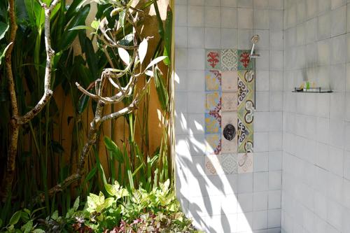 a shower in a bathroom with a tile wall at Villa with private pool at Villa Nirvana Ubud in Ubud