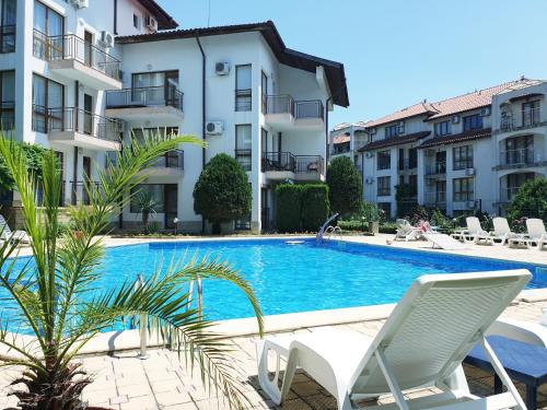 a swimming pool in front of some buildings at La terrace Sea view in Sveti Vlas