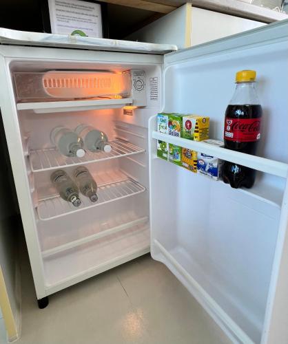 an open refrigerator with food and drinks in it at Grandblue Condominium#702 Seaview TopFloor MaePhim Rayong in Mae Pim