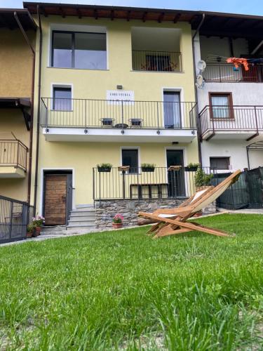 a pile of wood sitting in the grass in front of a building at Foresteria Cà di Nadin in Carriola
