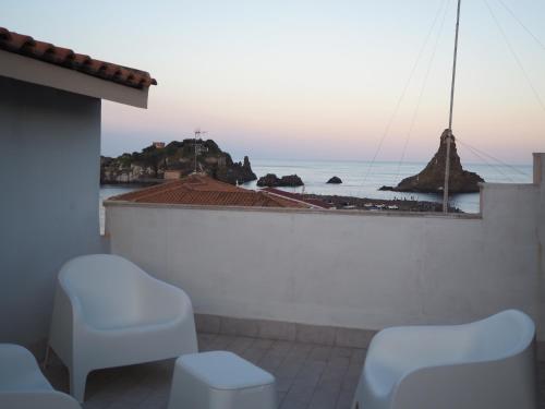 a view of the ocean from the balcony of a house at Le Omeriche dimore di Acitrezza in Acitrezza