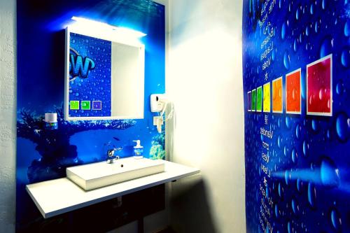 a bathroom with a sink and a mirror at Affittacamere Pavia in Pavia