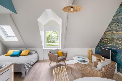 Habitación pequeña en el ático con cama y sofá en Horizons Lointains - Côté Mer - Belle vue mer, en Saint-Benoît-des-Ondes
