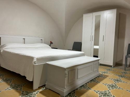 1 dormitorio con 1 cama blanca y armario blanco en Appartamento Tedesco, en Trapani