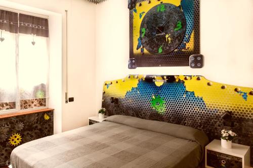 a bedroom with a bed with a colorful headboard at Affittacamere Pavia in Pavia