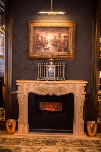 a fireplace in a room with a painting on the wall at Radisson Hotel Muscat Panorama in Muscat