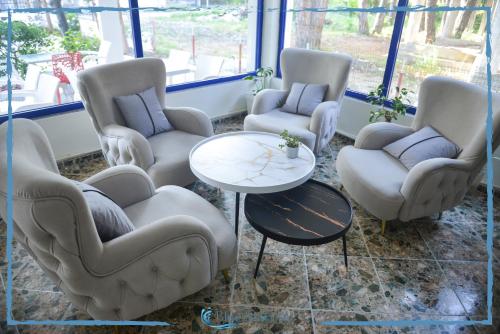 a waiting room with chairs and a coffee table at Blue Balcony Hotel in Golem