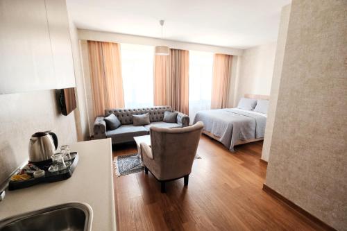 a living room with a bed and a couch at SABİHA GOKCEN İSTANBUL HOUSES Airport in Istanbul