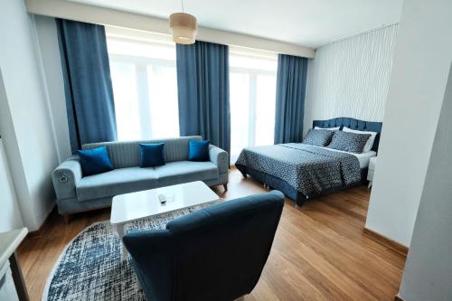 a living room with a couch and a bed at SABİHA GOKCEN İSTANBUL HOUSES Airport in Istanbul