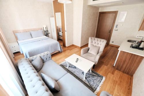 a living room with a couch and a bed at SABİHA GOKCEN İSTANBUL HOUSES Airport in Istanbul
