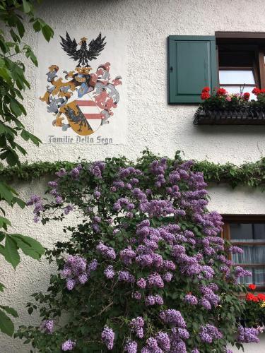 a sign on the side of a building with purple flowers at Arlenheim in Sankt Anton am Arlberg