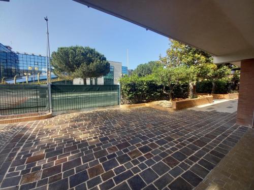 a brick patio with a fence and trees in a city at B&B LE MAGNOLIE in Termoli