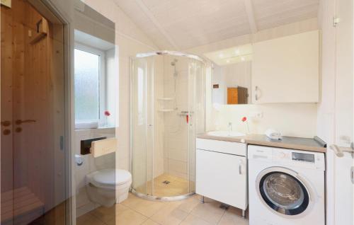 a bathroom with a washing machine and a toilet at St, Andreasberg, Haus 26 in Sankt Andreasberg