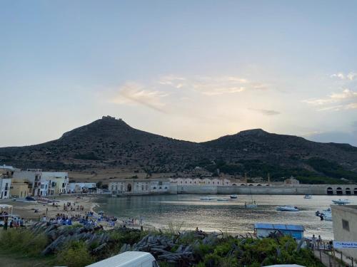 a view of a beach with a mountain in the background at Casa Emma in Favignana
