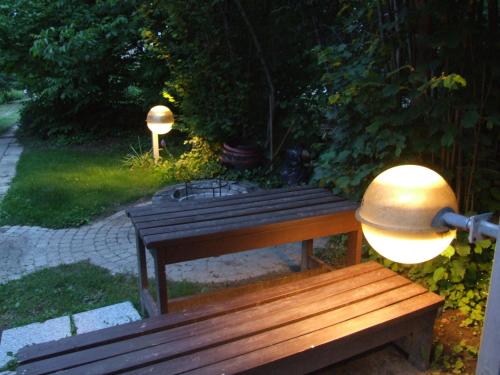 a wooden bench with a light on top of it at Simon Vendégház in Badacsonytördemic