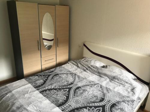 a bedroom with a bed and a cabinet with a surfboard at sweet home in Nemila