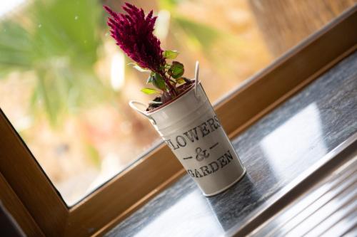 a flower in a vase sitting on a window sill at Blossom Farmhouses in Għasri