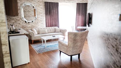 a living room with a couch and a table at SABİHA GOKCEN İSTANBUL HOUSES Airport in Istanbul