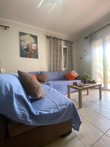 a bedroom with a bed and a couch and a table at dimitris house 2 in Alepou