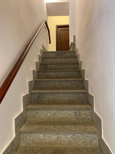 a set of stairs with a door in the background at La vecchia Cascina Rossa in Fubine