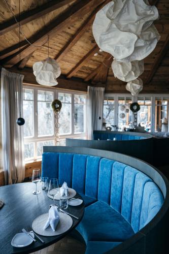 a dining room with a table and blue chairs at Boutiquehotel Blaue Burg Falkenstein in Pfronten